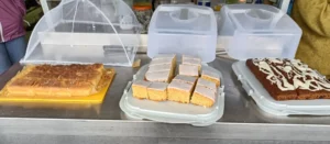 Lemon cake, lemon drizzle cake and carrot cake cut into squares for serving