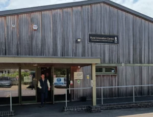 Rural skills centre building entrance. Wood clad exterterior with pitched roof