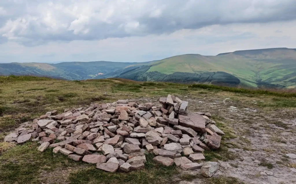 Pile of stones on ground. Mountains in the distance