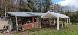 A large gazebo erected next to a permanent outdoor dining room