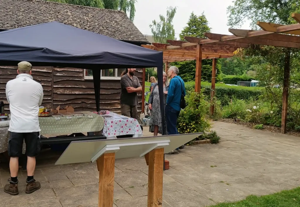 A gazebo with cakes and tea set up outdoors
