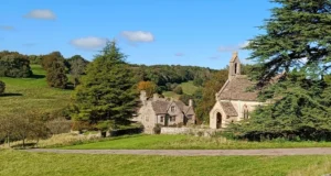 A church and manor house set in a secluded valley