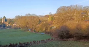 A village nestled in a valley next to a river