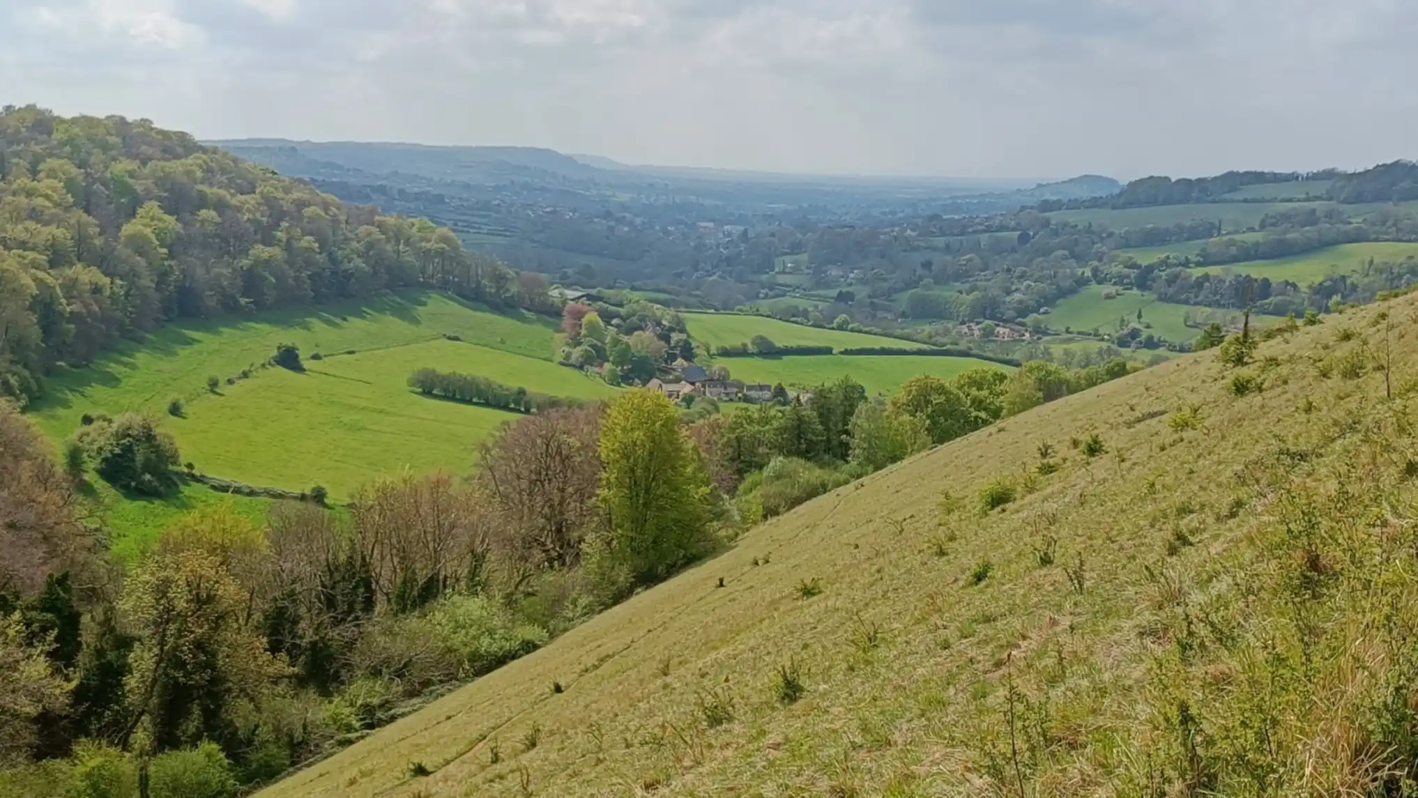 Wide valley view from the top of a hill. Town in distance
